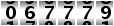 067779